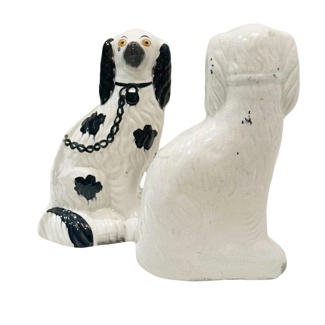 A pair of English Staffordshire spaniels in white with black spots. They are late 19th century and with wonderful color.