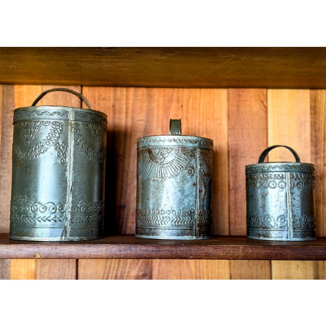 This set of antique Pennsylvania Dutch/German hand punched tin canisters likely date from the late 1800s - early 1900s....