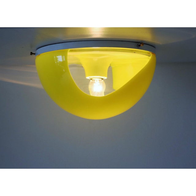 Gorgeous flush-mount light in sunny pop yellow - transparent murano glass, fixed with brass screws on a white aluminium...