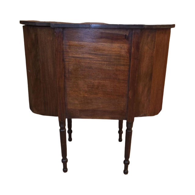A distinctive antique mahogany bow-front sideboard or server featuring an unusual architectural form with gracefully...