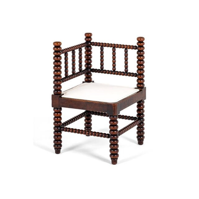 A superb oversized victorian bobbin corner chair in oak with a freshly upholstered calico seat cushion. The double railed...