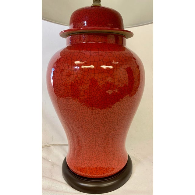 Contemporary Porcelain Temple Jar Table Lamp in a Red Crackle Finish on a Wooden Base With White Barrel Lampshade For Sale - Image 3 of 12