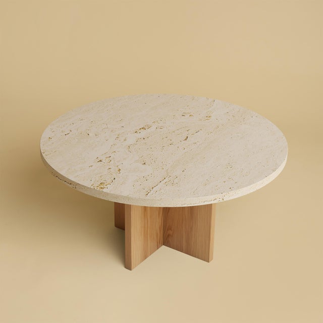 Roman travertine over a base of solid oak gives the Tinian its balance. It is a low table for the space in front of a...