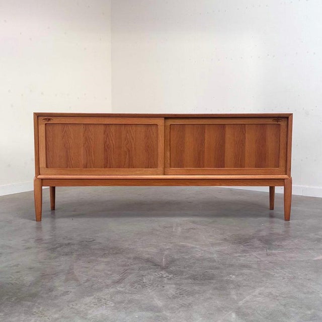 Remarks: Bramin sideboard designed by H.W. Klein, Denmark 1960s. Oak veneer with two slide doors. This sideboard is in a...