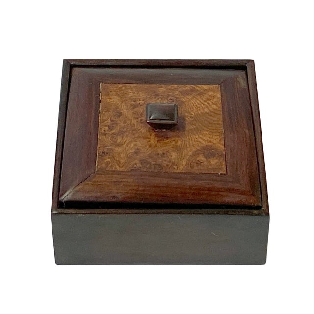 This is a small square wooden box with a lid. The top is showing off the beautiful burlwood pattern It may have wearout...