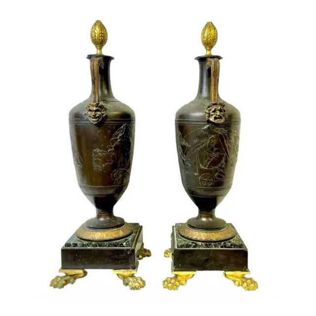 Pair of French Neoclassical Patinated Bronze and Marble Urn Vases in the Greco-Roman tradition. Each urn displays a tall,...