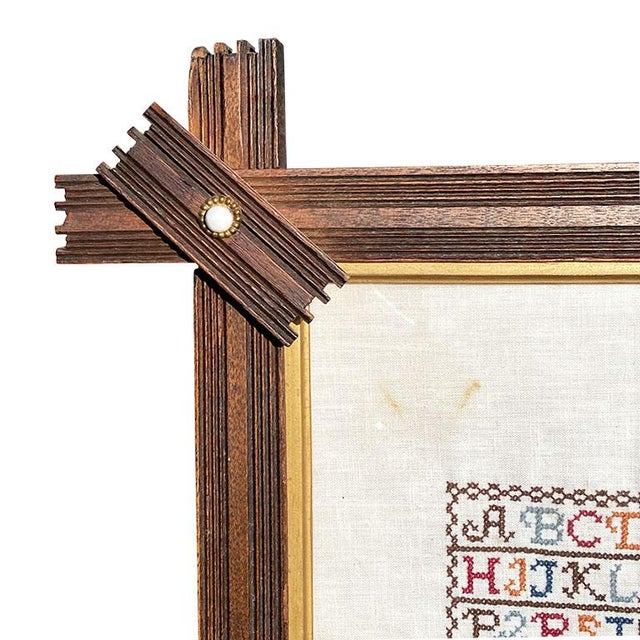 Framed in a folk art Starburst style wood frame, this embroidered sampler is a beautiful testament to the craftsmanship of...