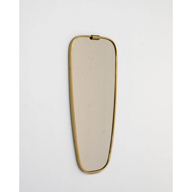 Wall mirror with brass frame. European production, 1950s. Wall mirror, European production, 1950s, typical of the Mid-...