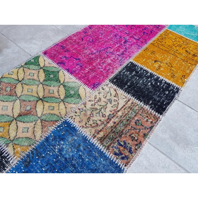 This is a vintage Turkish Oushak rug from the Mid 20th Century. The piece was hand-knotted.