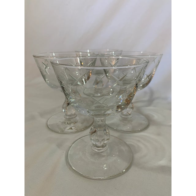 Vintage Mid Century Libbey Champagne Coupes in the Stardust pattern. Features a simple X cross cut star shape atop a more...