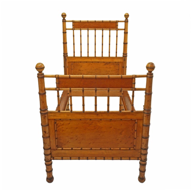 Charming antique French style faux bamboo bed frame with wonderful warmth, character, and versatility. Crafted in a...