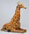 Italian Terracotta Hand Painted Resting Giraffe Sculpture. It is used in in good condition with normal natural wear....