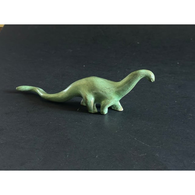 This miniature brontosaurus dinosaur figurine would make a cool gift or decor accent on your office desk, library shelf,...