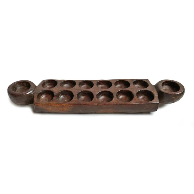 Old mancala game board. Rich dark brown stain and original signs of age and use. Game board only; does not include any...