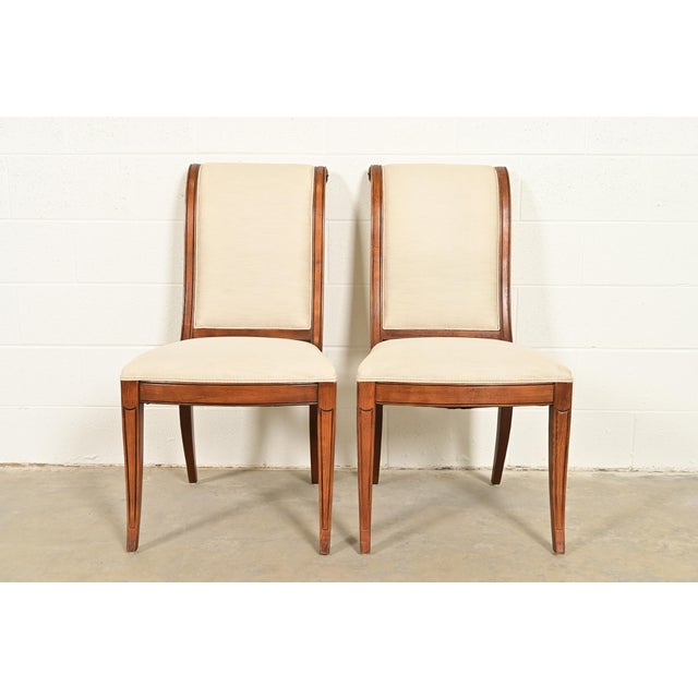 A gorgeous pair of French Regency Louis XVI style side chairs or dining chairs By Henredon USA, Circa 1980s Sculpted oak...