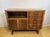 A stunning mid-century modern walnut sideboard and cocktail cabinet designed by františek jirák for tatra nábytok, dating...
