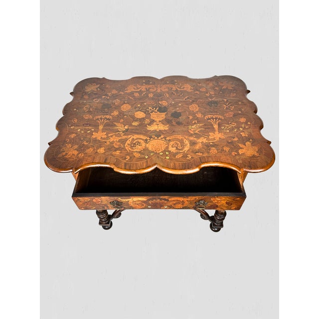 This beautiful marquetry table features all over inlay motifs. Floral, foliate, birds, acanthus leaves, scrolls, and a...