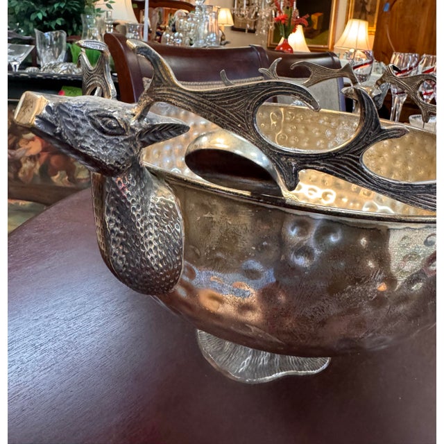 A striking silver-plated centerpiece by Andrea by Sadek, featuring a beautifully hammered bowl, sculptural elk-head...