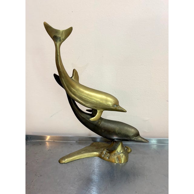 1970s-80s large brass double dolphin statue/sculpture. Some mild patina to metal throughout as shown.