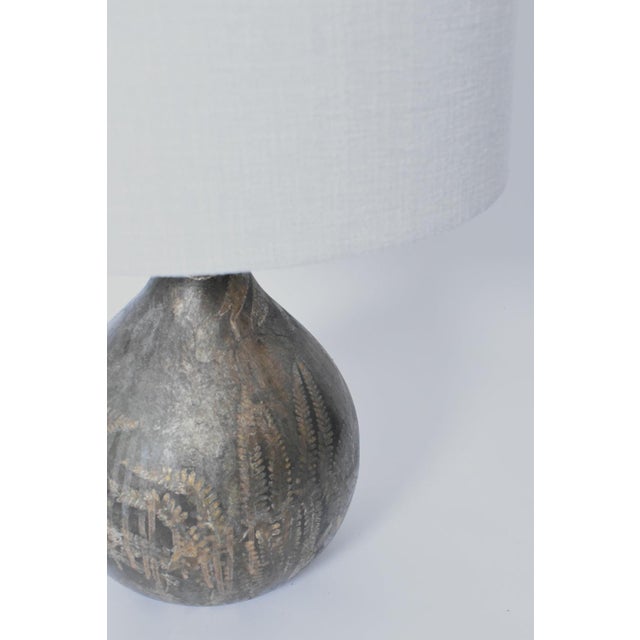 Foliage pattern painted glass lamp, 1960s. Glass painted table lamp with gold plants leaves decoration on a brown...