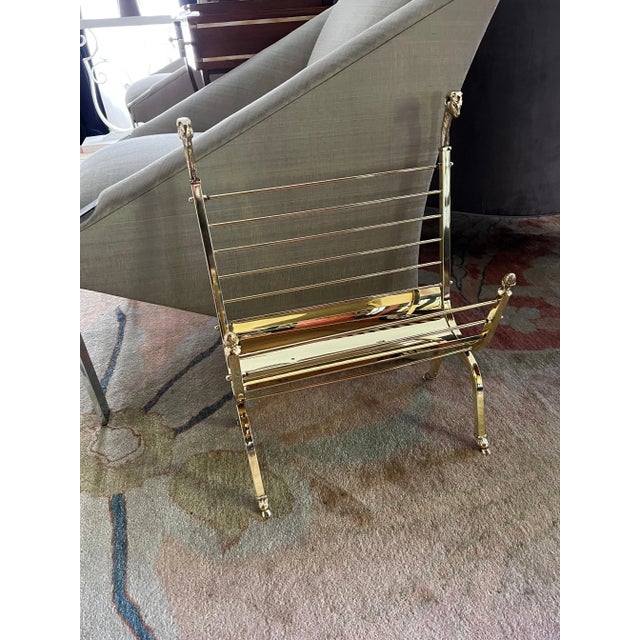 A wonderful brass magazine rack in the style of Maison Jansen. The rams heads and feet, in true Maison Jansen style set...