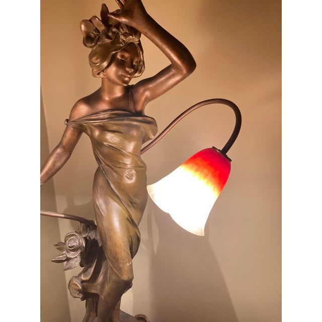 Combining the art of sculpture with functionality, this magnificent lamp displays the classic elegance of Art Nouveau...
