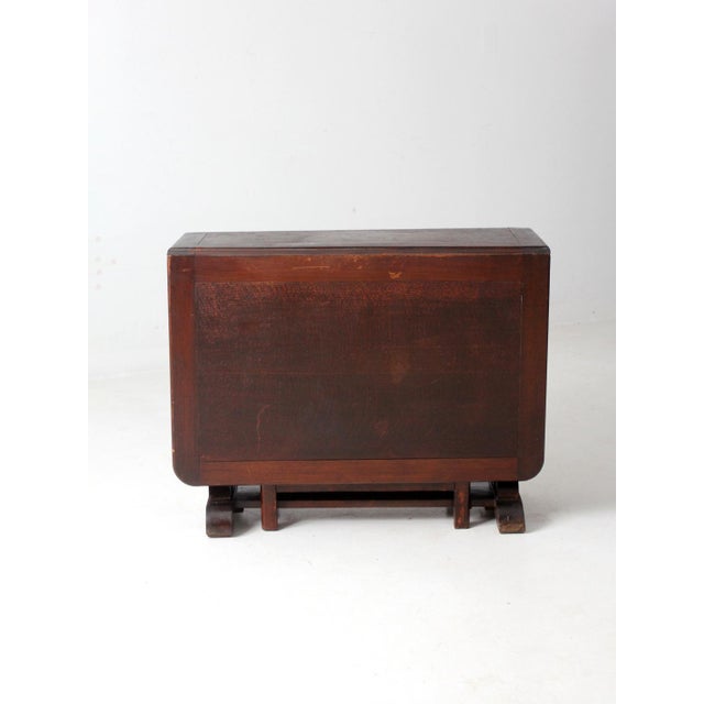 This is an antique drop leaf console table. The Victorian table features long drop leaves that open with turned gate legs....