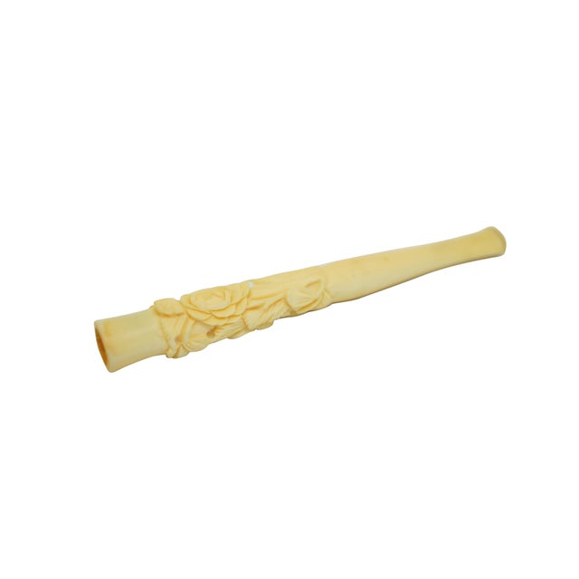 This vintage, cream-colored cigarette holder is crafted from genuine carved bone, tapering gently toward a flattened...