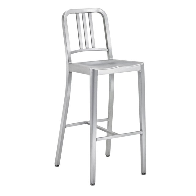The Emeco 1006 Bar Height Stool in Brushed Steel, also known as the Navy Stool, is a timeless icon originally designed in...