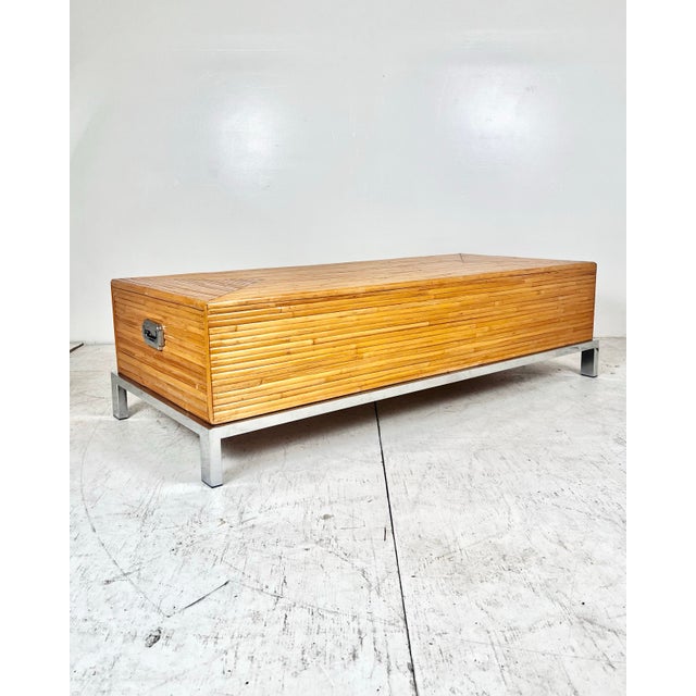 Vintage split reed rattan/bamboo coffee table in the style of Milo Baughman. Mounted on a chrome base with matching...