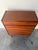 Vintage Danish Mid Century Modern teak tallboy dresser featuring elegant sculpted drawer pulls and tapered solid wood...