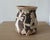 A sculptural American studio pottery bud vase from New York featuring an elaborate hand-incised and glazed woodland scene....