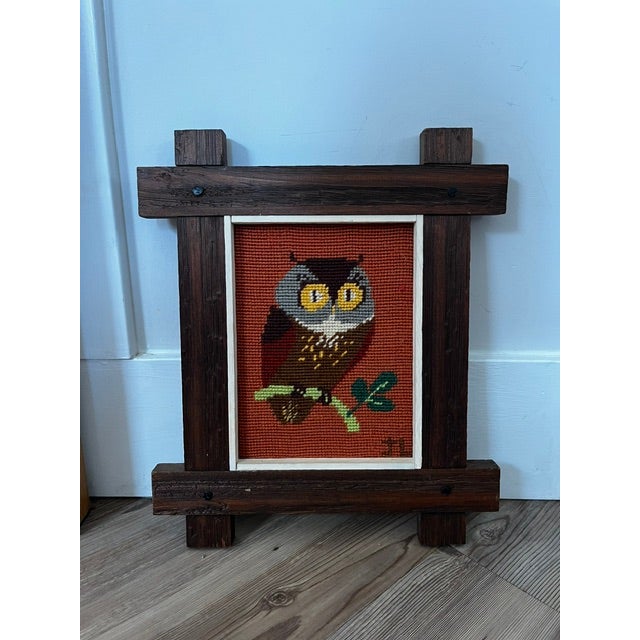 • The Artwork: Shows a brown and gray owl with bright yellow eyes perched on a green branch against a textured orange...