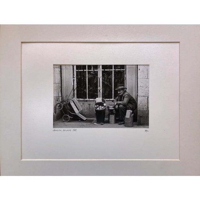 Vintage 1987 Black and White Street Photograph shot on film showing an old man selling apples in Cracow, then Communist...