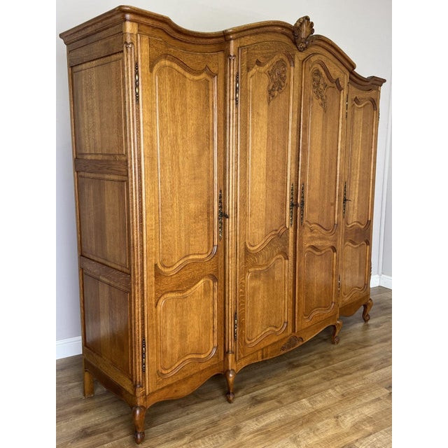 An impressive Vintage French Louis wardrobe , beautifully proportioned with an elegant shaped cornice, decorative carved...