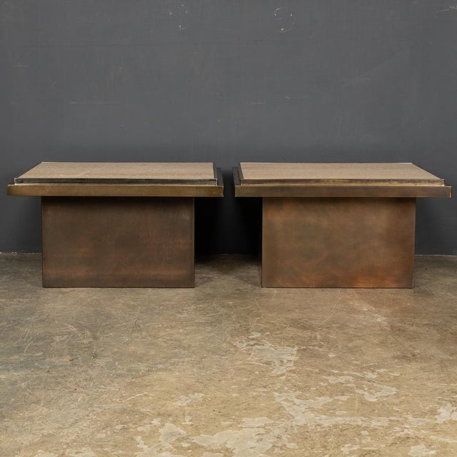 A stunning pair of end tables with Italian travertine marble tops framed in chrome on a bronze base made to the highest...