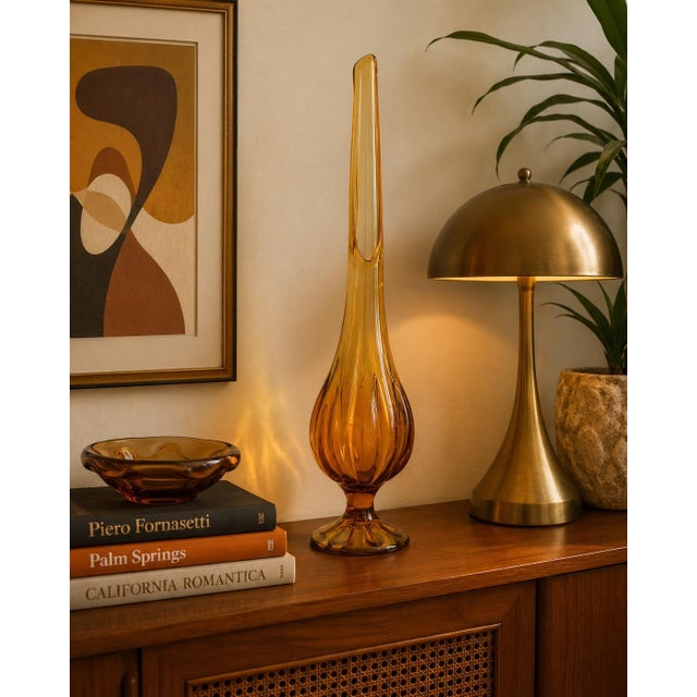A stunning vintage Viking art glass vase in a dramatic elongated swung form, showcasing the bold sculptural styling that...