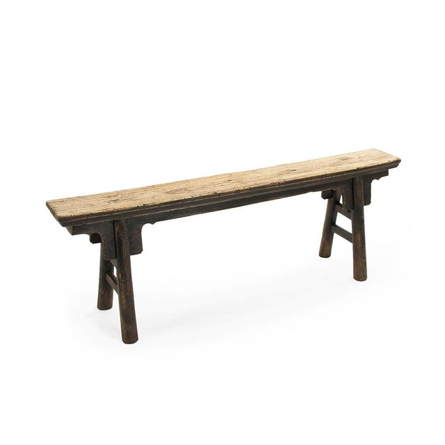 The Story Bench in Black from Zentique is a minimalist reclaimed elm bench with a thick plank seat on simple straight...