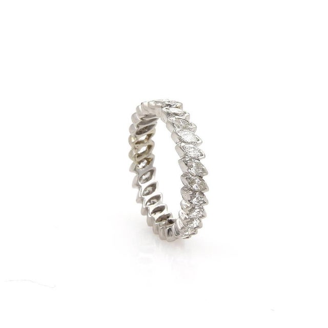 This lovely Eternity band ring is crafted from platinum with a polished finish. The band has a full circle of marquise cut...