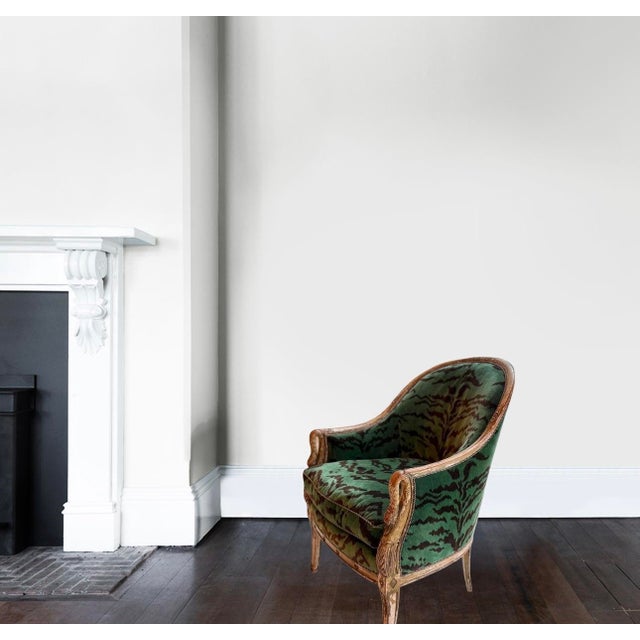 This is a beautiful and distinctive Louis XVI-style bergère, with finely carved painted wood frame and a classically and...