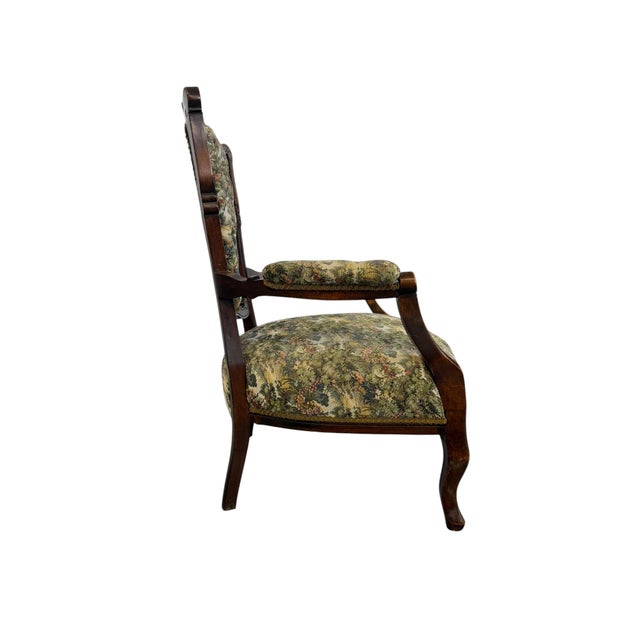 Antique Victorian parlor armchair showcases the masterful craftsmanship of the mid-to-late 19th century. with Intricate...