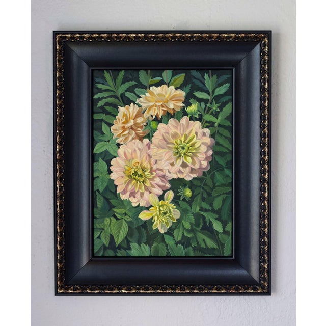This oil painting captures a vibrant cluster of blooming dahlias, showcasing their soft peach and yellow hues against a...