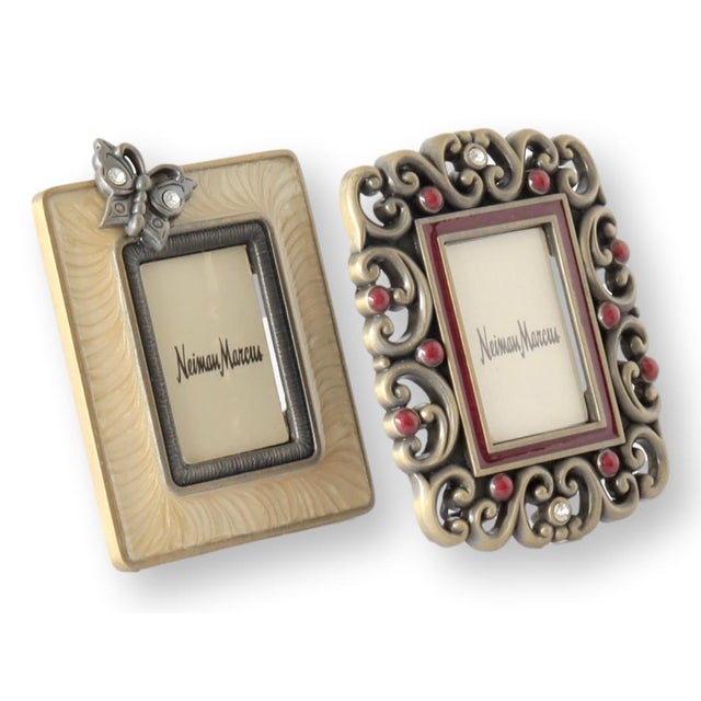 Pair of Jay Strongwater mini picture frames from Neiman Marcus. One features a butterfly atop ivory swirl enamel; the...