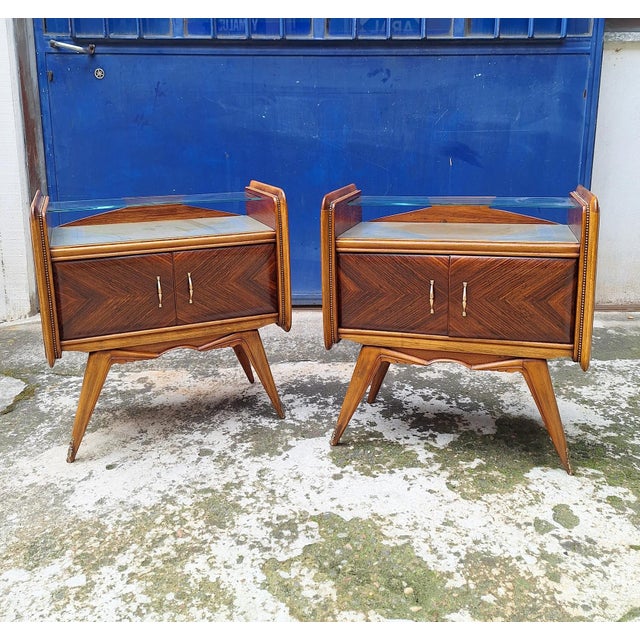 Pair of mid-century bedside tables made in Italy in the 1950s. The bedside tables are characterized by the use of teak and...