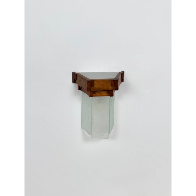 Exceptional and unique wall sconce produced in the early 1930s. Timeless design, perfect craftsmanship. Numerous geometric...