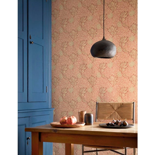 Curling acanthus leaves and speckled fruits animate this wallpaper originally designed by William Morris in 1877 and used...