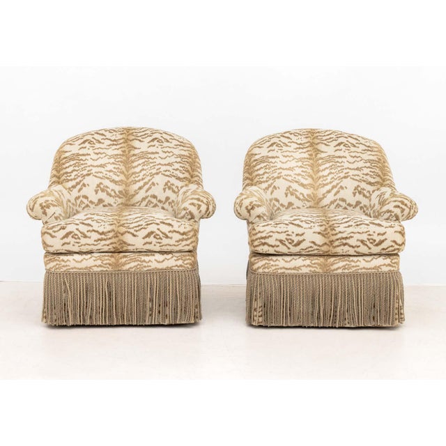 Pair of Lee Jofa Tiger Print Upholstered Swivel Arm Chairs, in white and tan with tassel trim, "Lee Jofa / Furnishings"...