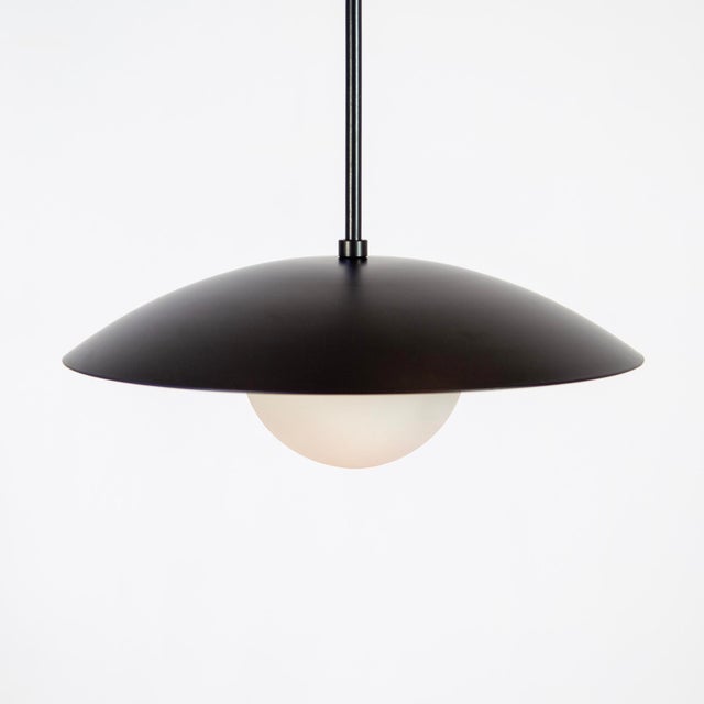 The Dome Pendant Light floats — a well-proportioned fixture that couples a glass orb with powder coated steel. It’s...