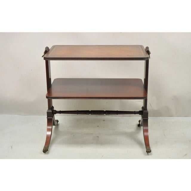 Vintage Mahogany 2 Tier Brown Tooled Leather Top Accent Side End Table. Item features brass lion drop pulls, tooled...