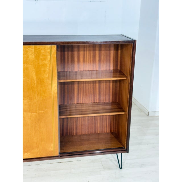 For sale is this beautiful display cabinet from the 1960s, in good condition. It captivates with its combination of two...